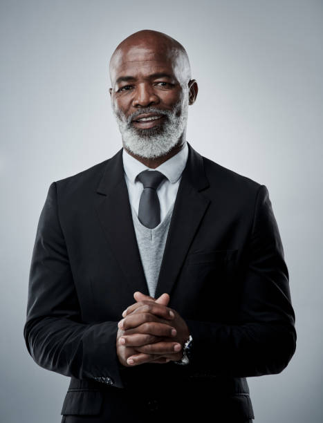 studio portrait of a mature businessman against a grey background